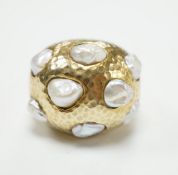 A planished 9ct and baroque pearl cluster set domed dress ring, size L, gross weight 17.1 grams.