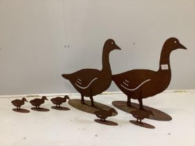 A contemporary cut metal garden ornament group, two geese and goslings, largest height 55cm