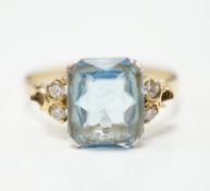 A yellow metal, single stone aquamarine and four stone diamond chip set dress ring, size M, gross