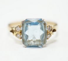 A yellow metal, single stone aquamarine and four stone diamond chip set dress ring, size M, gross