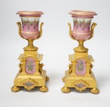 A pair of late 19th century French ormolu and pink floral porcelain urns, 20.5cm high