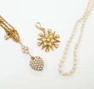 An Edwardian 15ct gold and seed pearl set starburst pendant, overall 25mm, together with a similar