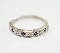 A modern 9ct white hold sapphire and diamond chip set half hoop ring, size N, gross weight 2.1