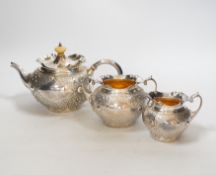 A Victorian embossed silver three piece bachelors tea set, Charles Edwards, London, 1880, gross
