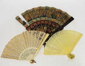 An early 20th century Chinese painted and lacquer fan, together with two others