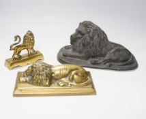 A 19th century brass recumbent lion, a similar cast iron lion and a smaller lion, largest 22cm wide
