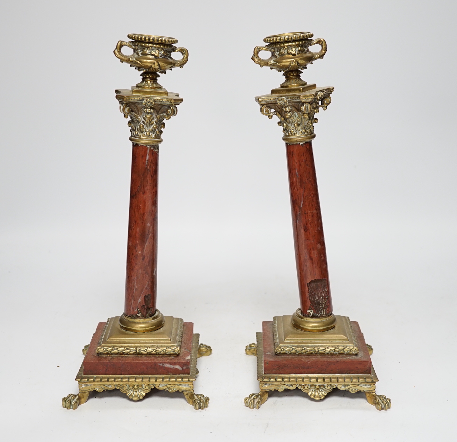 A pair of 19th century brass mounted rouge marble candlesticks, 29cm (a.f.)