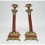 A pair of 19th century brass mounted rouge marble candlesticks, 29cm (a.f.)