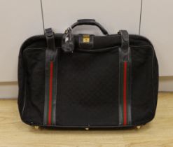 A black fabric and leather trimmed Gucci suitcase Condition worn