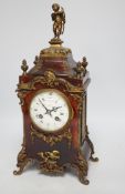 A late 19th century French tortoiseshell veneered mantel clock with cupid top, striking on a