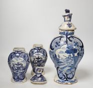 An 18th century Delft blue and white vase and a pair of later Delft vases and covers, tallest 23.