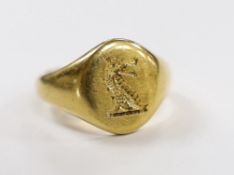 A gentleman's 1970's 18ct gold oval signet ring, carved with family crest, size Q, 11.8 grams.