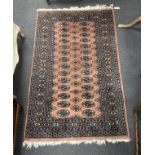 A Bokhara peach ground rug, 164 x 102cm