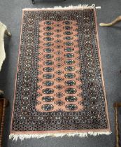 A Bokhara peach ground rug, 164 x 102cm