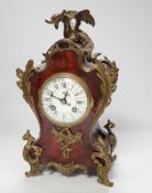An early 20th century French red tortoiseshell veneered mantel clock with dragon mount, 30cm