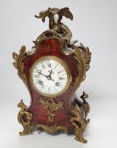 An early 20th century French red tortoiseshell veneered mantel clock with dragon mount, 30cm
