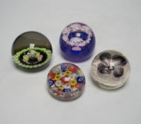 A collection of nineteen glass paperweights; mostly Caithness with two being Whitefriars and another