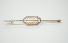 A Belle Epoque 15ct, diamond and seed pearl set bar brooch, 63mm, gross weight 3.9 grams.