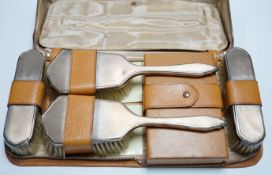 A cased 1950's engine turned silver mounted six piece mirror and brush set.