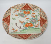 A 19th century Japanese dish, painted with peonies, within a square, 40cms. dia.
