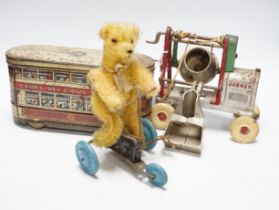 Three tinplate/cast iron toys; a Jaeger cast iron concrete mixer, a Carr’s tinplate biscuit tin in