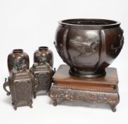 A Meiji period Japanese bronze jardiniere, a pair of cloisonné vases, a hardwood stand, etc.