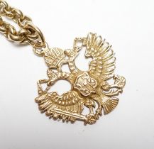 An Austrian yellow metal double eagle pendant, width 31mm, on a 9ct gold belcher link chain, 62cm,