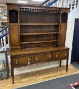 An 18th century oak dresser with boarded rack, width 182cm, depth 45cm, height 211cm