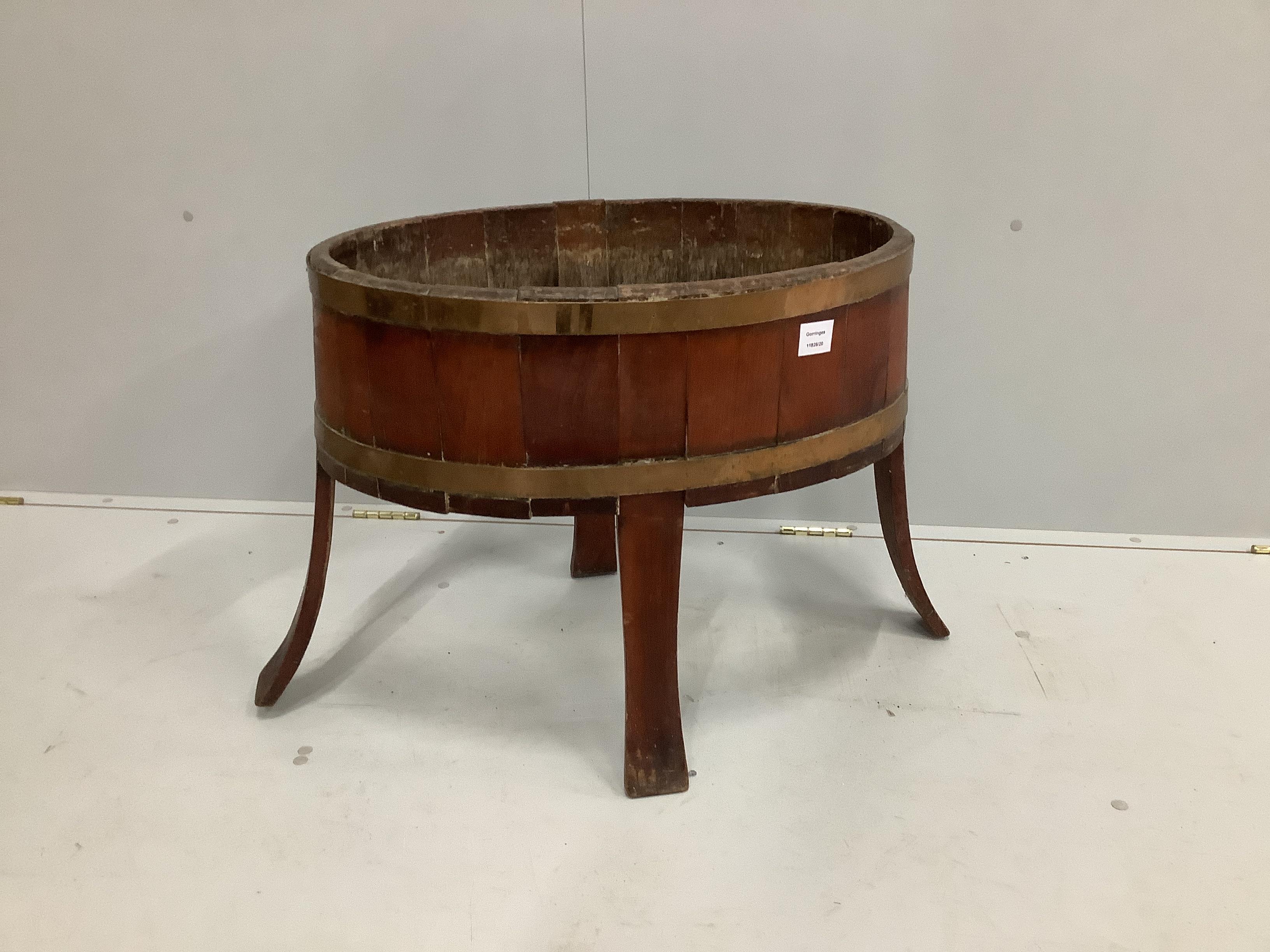 A George III oval brass bound mahogany wine cooler, lacking base and liner, width 75cm, depth