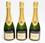 Three half bottles of Krug Grande Cuvee Champagne.