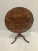 A George III circular oak tilt top tripod tea table, diameter 75cm, height 70cm