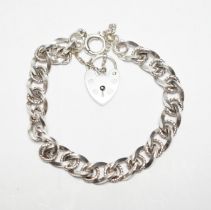 A modern silver curb and rope twist link bracelet, with heart shaped padlock clasp, 18cm.