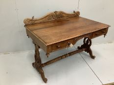 An Anglo-Indian carved hardwood writing table, two frieze drawers, on scrolled end supports, width