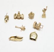 A 585 'Cable car' charm, 1.4 grams, three 9ct gold charms, 9.9 grams and four other yellow metal