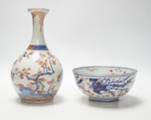 An 18th century Japanese Imari sake flask and a Chinese clobbered blue and white bowl (a.f), tallest