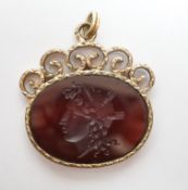 A yellow metal mounted oval intaglio agate? pendant, carved with the bust of a lady to dexter, width