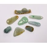 Eight various Chinese carved jadeite pendants
