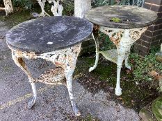 A near pair of Victorian cast iron Britannia pub tables, one with weathered stone top, the other