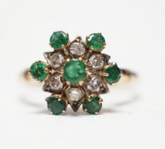 A 14ct, emerald and diamond set flowerhead cluster ring, size N/O, gross weight 3.2 grams.