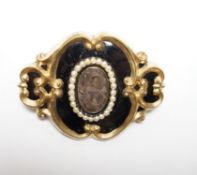 A Victorian yellow metal, black enamel and seed pearl set mourning brooch, 47mm.