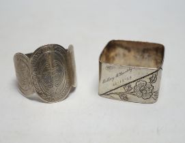 Two Chinese engraved white metal napkin rings.