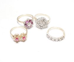 A modern 9ct gold, ruby and simulated diamond cluster set flower head ring, size N and three other