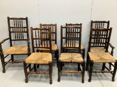 A harlequin set of seven 19th century Lancashire rush seat ladder back dining chairs, two with arms