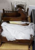 A mahogany crib, a doll's bed and bedding and a painted wooden rocking cradle and a Victorian cast