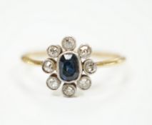 An 18ct, sapphire and diamond cluster set oval ring, size M, gross weight 2 grams.