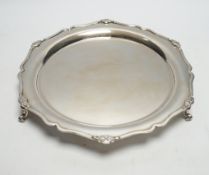 A George V silver shaped circular salver, on three scroll feet, Martin, Hall & Co, Sheffield,