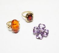 A 333 yellow metal and amber set ring, a 585 and gem set ring and an amethyst and seed pearl set