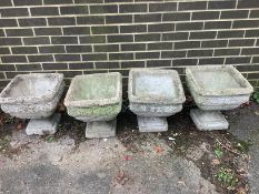 Two pairs of square reconstituted stone garden planters with plinth bases, height 40cm