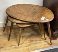 A nest of three Ercol light elm tea tables, width 65cm, depth 43cm, height 38cm