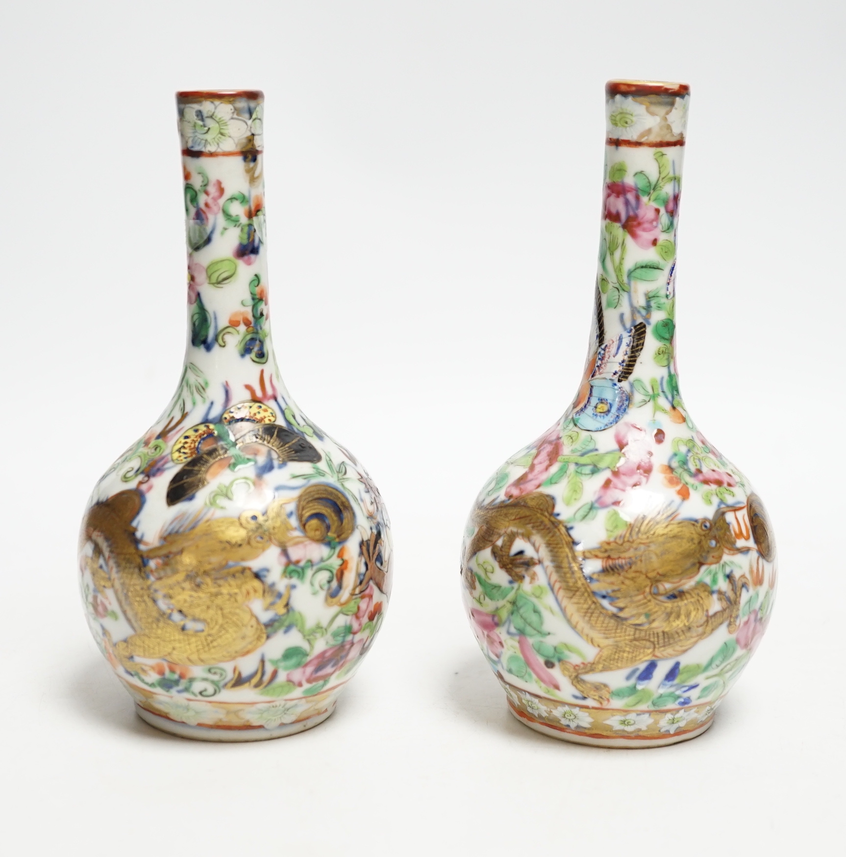 A pair of 19th century Chinese clobbered famille rose 'dragon' bottle vases, 15.5cm